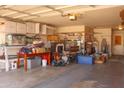 Well-lit garage interior with storage shelves and functional workspace at 10603 W Ruth Ave, Peoria, AZ 85345