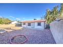 View of backyard with decorative rock landscaping and metal roof at 10917 W Apache St, Avondale, AZ 85323