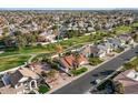 An aerial view showcases this charming neighborhood with mature trees and manicured lawns at 1101 N Peppertree Dr, Gilbert, AZ 85234