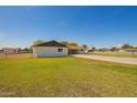 Large backyard featuring manicured lawns, secure fencing and a wide driveway at 15202 N 71St Dr, Peoria, AZ 85381