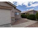 Charming single-story home with desert landscaping, stone accents, and a two-car garage at 15351 W Port Royale Ln, Surprise, AZ 85379