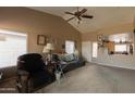 Inviting living room with vaulted ceilings, cozy seating, and abundant natural light at 15351 W Port Royale Ln, Surprise, AZ 85379