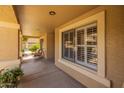 Inviting front porch with neutral finishes, offering an airy and welcoming entryway at 16577 W Garfield St, Goodyear, AZ 85338