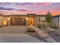 Charming single-story home with a two-car garage, desert landscaping, and a paver walkway at 175 E Santa Lucia Ln, Queen Creek, AZ 85140