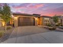 Beautiful single-story home with a two-car garage at sunset, showcasing the well-manicured yard at 175 E Santa Lucia Ln, Queen Creek, AZ 85140