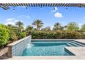 Stunning pool area with waterfall feature, desert landscaping and covered patio at 175 E Santa Lucia Ln, Queen Creek, AZ 85140