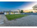Expansive backyard featuring a spacious lawn, modern patio stones, and a clean gravel area, great for outdoor gatherings at 1868 E La Donna Dr, Tempe, AZ 85283
