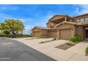 Exterior townhome facade featuring private balcony, stone accents, and spacious two-car garages at 1945 W Desert Vista Trl # 77, Phoenix, AZ 85085