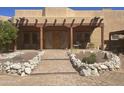 Charming Southwestern-style home with a welcoming front porch and professionally landscaped front yard at 20042 W Colter St, Litchfield Park, AZ 85340