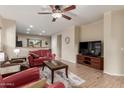 Comfortable living room with tile floors, a ceiling fan, and an open concept layout at 20555 N 261St Ave, Buckeye, AZ 85396