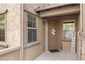 Charming front entrance with decorative wreath and welcome sign, framed by dual windows at 2118 W Hunter Ct # 136, Phoenix, AZ 85085