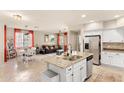 Open-concept kitchen with island featuring granite countertops, stainless steel appliances, and view of dining area at 2118 W Hunter Ct # 136, Phoenix, AZ 85085