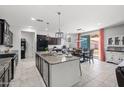 Spacious kitchen with island, granite countertops, stainless appliances, and adjacent dining area offering an open layout at 21407 W Hubbell St, Buckeye, AZ 85396