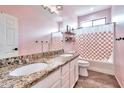 Charming bathroom with double vanity, granite counters, and a shower-tub combo at 2210 W Goldmine Mountain Dr, Queen Creek, AZ 85144