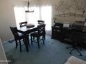 Cozy dining room with dark wood table and chairs, complemented by natural light and an office space at 2400 E Baseline Ave # 153, Apache Junction, AZ 85119