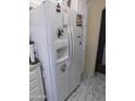 Modern white refrigerator with water dispenser and decorative magnets in the kitchen at 2400 E Baseline Ave # 153, Apache Junction, AZ 85119