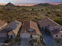 Breathtaking aerial view of a home surrounded by desert landscape and mountain views at 26743 N 65Th Dr, Phoenix, AZ 85083