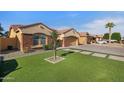 Charming single-Gathering home featuring a two-car garage and artificial turf lawn at 3592 E Sandwick Dr, San Tan Valley, AZ 85140