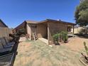 This backyard features a large covered patio with desert landscaping at 3621 N 65Th Ave, Phoenix, AZ 85033