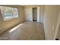 Bedroom featuring tile floors, a window, and a closet with plenty of storage space at 3645 N 71St Ave # 28, Phoenix, AZ 85033