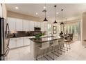 Modern kitchen with a large island, granite countertops, and stainless steel appliances at 3910 N 163Rd Dr, Goodyear, AZ 85395