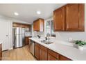 Well-lit kitchen with stainless steel appliances, light countertops, and hardwood cabinets at 3925 E Arbor Ave, Mesa, AZ 85206