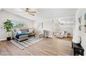 Open living room showcasing hardwood floors, a comfortable seating area, and bright natural light at 3925 E Arbor Ave, Mesa, AZ 85206