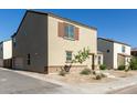 Two story beige house with tiled roof, landscaped front yard, and concrete walkway to the front door at 3929 S 79Th Ln, Phoenix, AZ 85043