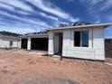 New house showing the covered porch, open garage and incomplete exterior insulation at 4344 E Brook Lynn Pl, San Tan Valley, AZ 85140