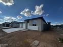 New construction home featuring a three-car garage and desert landscaping at 4344 E Brook Lynn Pl, San Tan Valley, AZ 85140