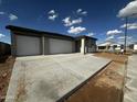 New construction home featuring a three-car garage and a concrete driveway at 4344 E Brook Lynn Pl, San Tan Valley, AZ 85140