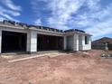 New home shows open garage and front porch, in the middle of the construction phase with insulation at 4344 E Brook Lynn Pl, San Tan Valley, AZ 85140