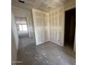 Hallway view showcasing unfinished walls and ceiling, leading towards sliding glass doors to the backyard at 4344 E Brook Lynn Pl, San Tan Valley, AZ 85140