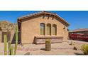Single-story home showcasing desert landscaping, a stucco exterior, and a red disposal container at 464 W Bismark St, San Tan Valley, AZ 85143