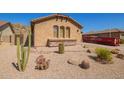 Single-story home showcasing desert landscaping, a stucco exterior, and a red disposal container at 464 W Bismark St, San Tan Valley, AZ 85143