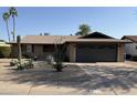 Single-story home featuring desert landscaping, a covered entrance, and a two-car garage at 510 E Fremont Dr, Tempe, AZ 85282