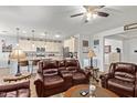 Inviting living room featuring comfortable leather seating, neutral walls, and wood-look floors at 5218 W Lydia Ln, Laveen, AZ 85339