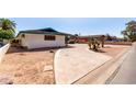 Spacious driveway leading to a charming home with unique architectural details and desert landscaping at 537 N Jay St, Chandler, AZ 85225