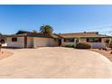Wide shot of a ranch-style home with a circular driveway, desert landscaping, and an attached garage at 537 N Jay St, Chandler, AZ 85225