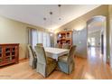 This dining room features a chandelier, hardwood floors and provides plenty of room for entertaining at 5674 W North Ln, Glendale, AZ 85302