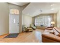 Inviting living room with plenty of natural light from the large windows and hardwood floors throughout at 5674 W North Ln, Glendale, AZ 85302