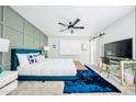 Bright bedroom featuring stylish decor, soft carpet and a modern ceiling fan at 5929 S Lakeshore Dr, Tempe, AZ 85283