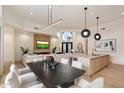 Open-concept living space featuring a fireplace, dining area, and kitchen with modern lighting and decor at 7705 E Doubletree Ranch Rd # 51, Scottsdale, AZ 85258