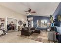 Spacious living room with tiled floors, blue accent wall, and comfortable seating area at 7908 W Rose Garden Ln, Peoria, AZ 85382