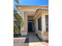 Close-up of the front entrance of a charming home with a 'HOME' sign and desert landscaping at 8535 W Willow Ave, Peoria, AZ 85381
