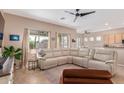 Spacious living room with a comfortable sectional sofa and views into the backyard at 1085 W Ayrshire Trl, San Tan Valley, AZ 85143
