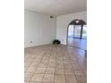 Bright living room features neutral walls, tiled floors, arched doorway, and natural light at 11038 N 53Rd Dr, Glendale, AZ 85304