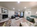 Comfortable living room featuring a fireplace, leather sectional and neutral decor at 1425 E Desert Cove Ave # 35, Phoenix, AZ 85020