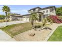 Well-maintained home boasts desert landscaping, vibrant bougainvillea, and a spacious three-car garage at 14754 W Amelia Ave, Goodyear, AZ 85395