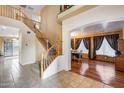 Inviting entryway with tile flooring, a staircase, and an archway leading to the dining area at 1517 E Elaine Dr, Casa Grande, AZ 85122